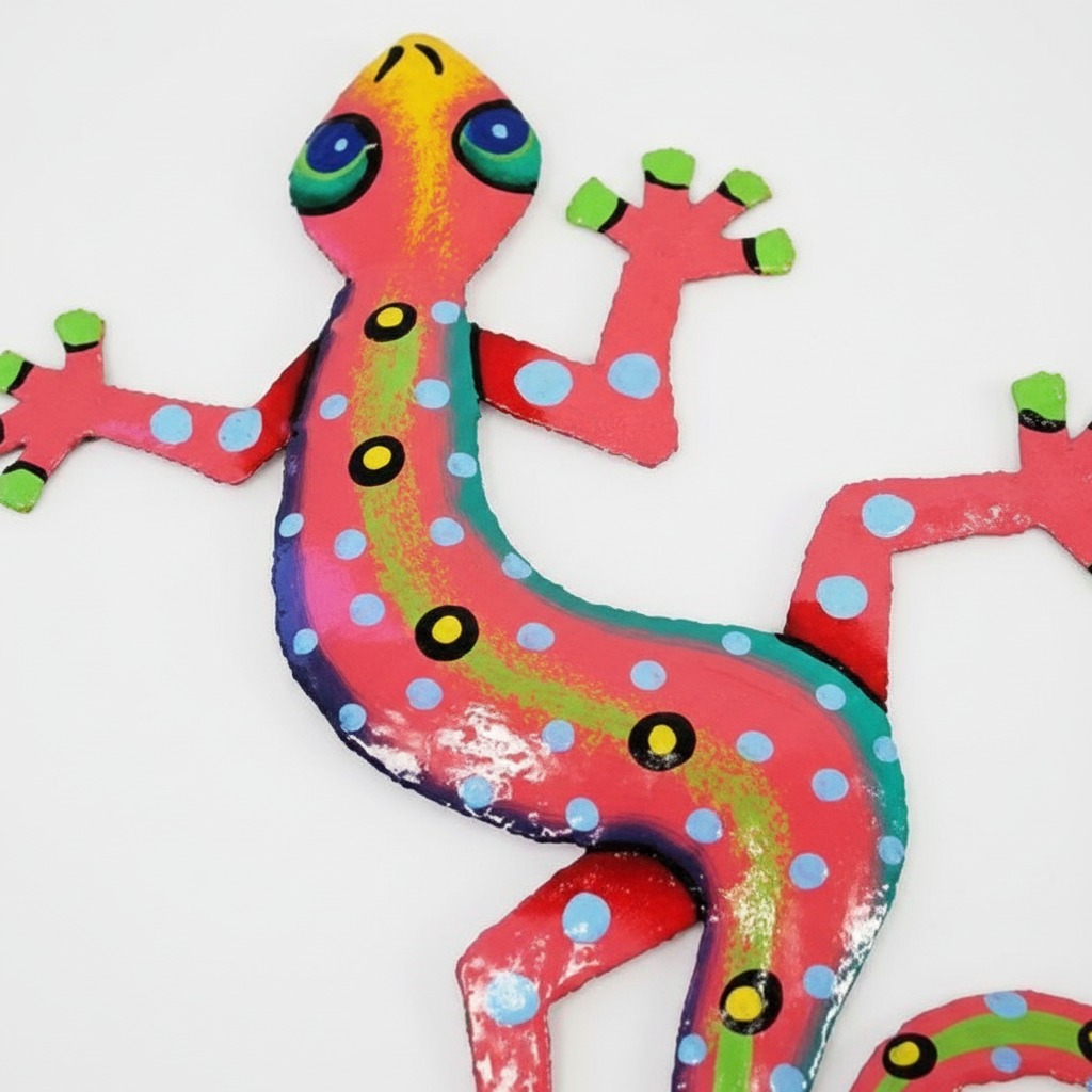 Close-up detail of handcrafted pink metal gecko showing hand-painted texture and vibrant colors